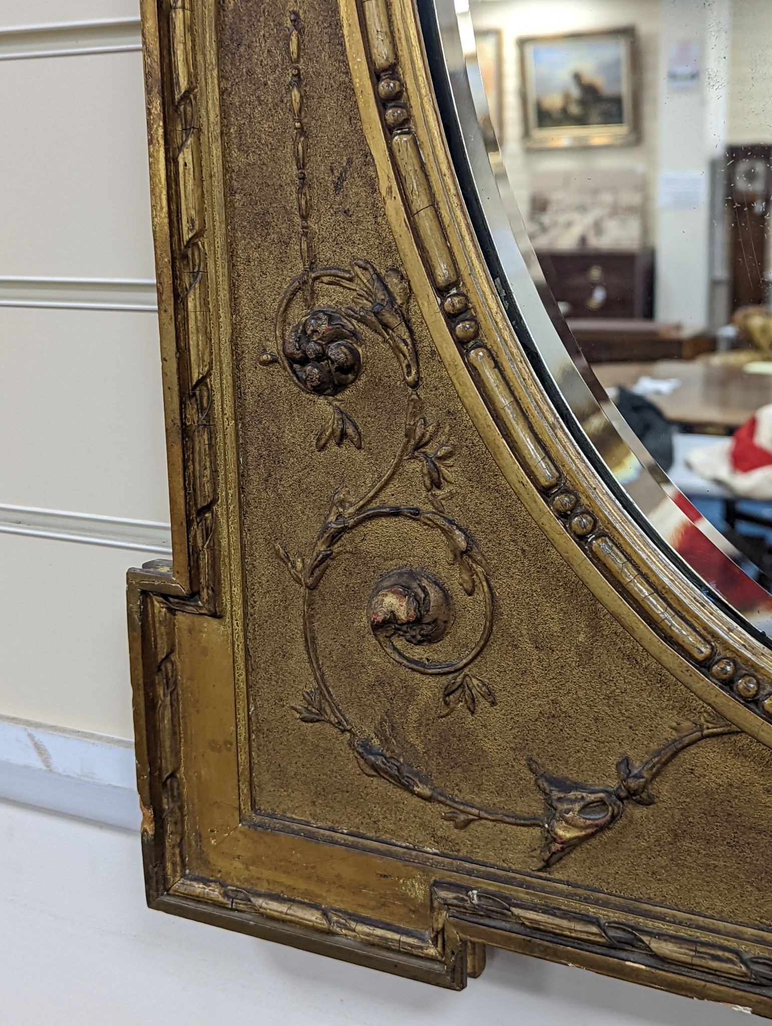 A Victorian style rectangular giltwood and gesso wall mirror, floral swag to top, with oval plate, width 70cm, height 92cm